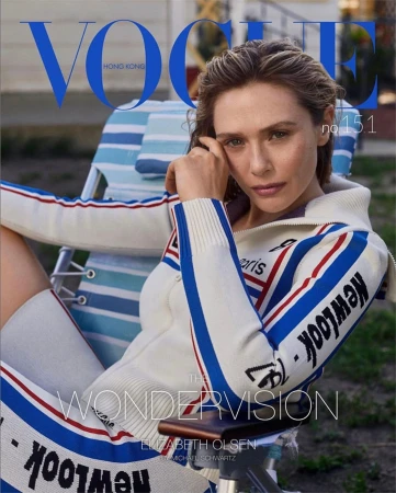 Vogue Hong Kong cover featuring Elizabeth Olsen sitting on a blue and white striped chair wearing a white and blue tracksuit.