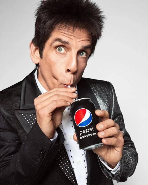 Adult male in formal wear drinks Pepsi Zero Sugar from a can with a straw in a photo studio setting.