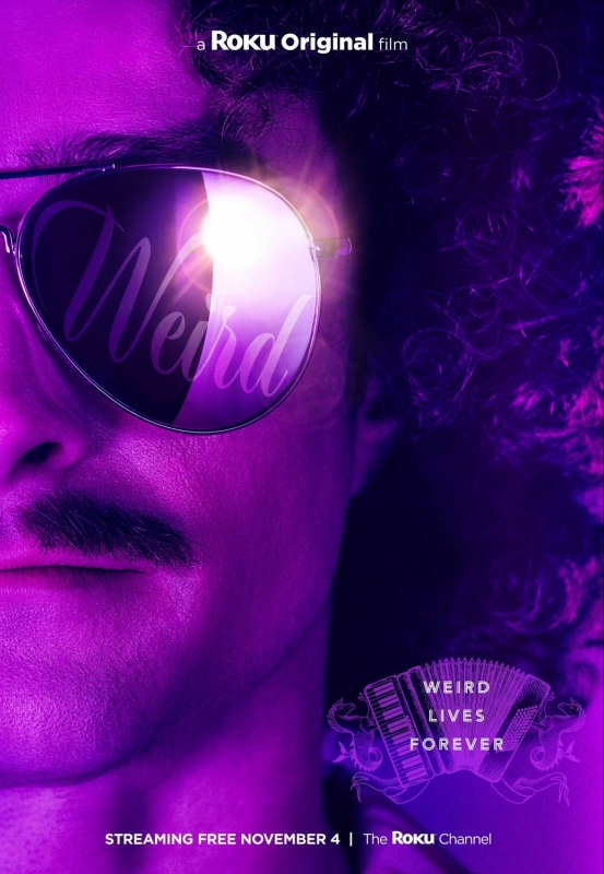 Close-up portrait of a man with curly hair and glasses with the word 'Weird' reflected in the lenses, set against a purple background.