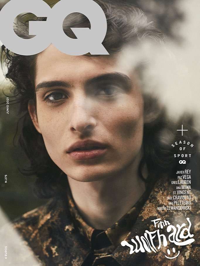Magazine cover featuring Finn Wolfhard in close-up, wearing patterned shirt, GQ logo and text elements visible, soft lighting.