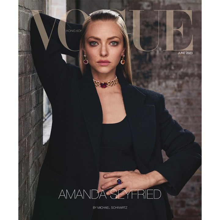 Amanda Seyfried poses in black blazer with striking red jewelry on Vogue Hong Kong cover, June 2023, against a textured wall.