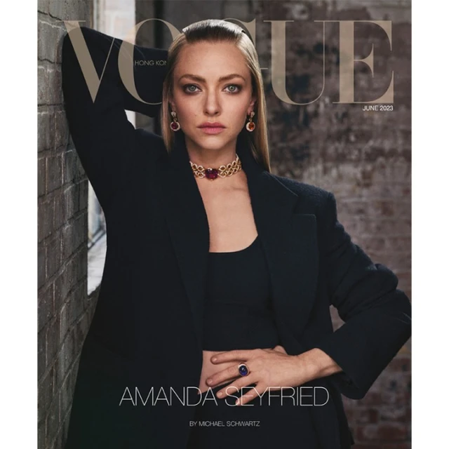 Amanda Seyfried poses in black blazer with striking red jewelry on Vogue Hong Kong cover, June 2023, against a textured wall.