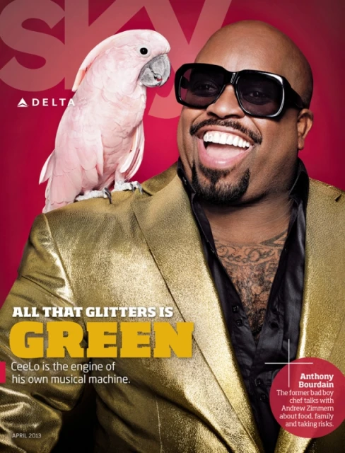 Magazine cover featuring singer CeeLo Green wearing a gold jacket with a pink cockatoo perched on his shoulder, against a red background.
