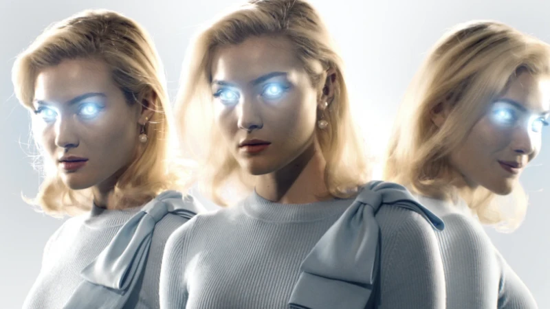 Blonde woman with glowing eyes is tripled, wearing a ribbed light blue top with bow, accessorized with pearl earrings in bright studio lighting.