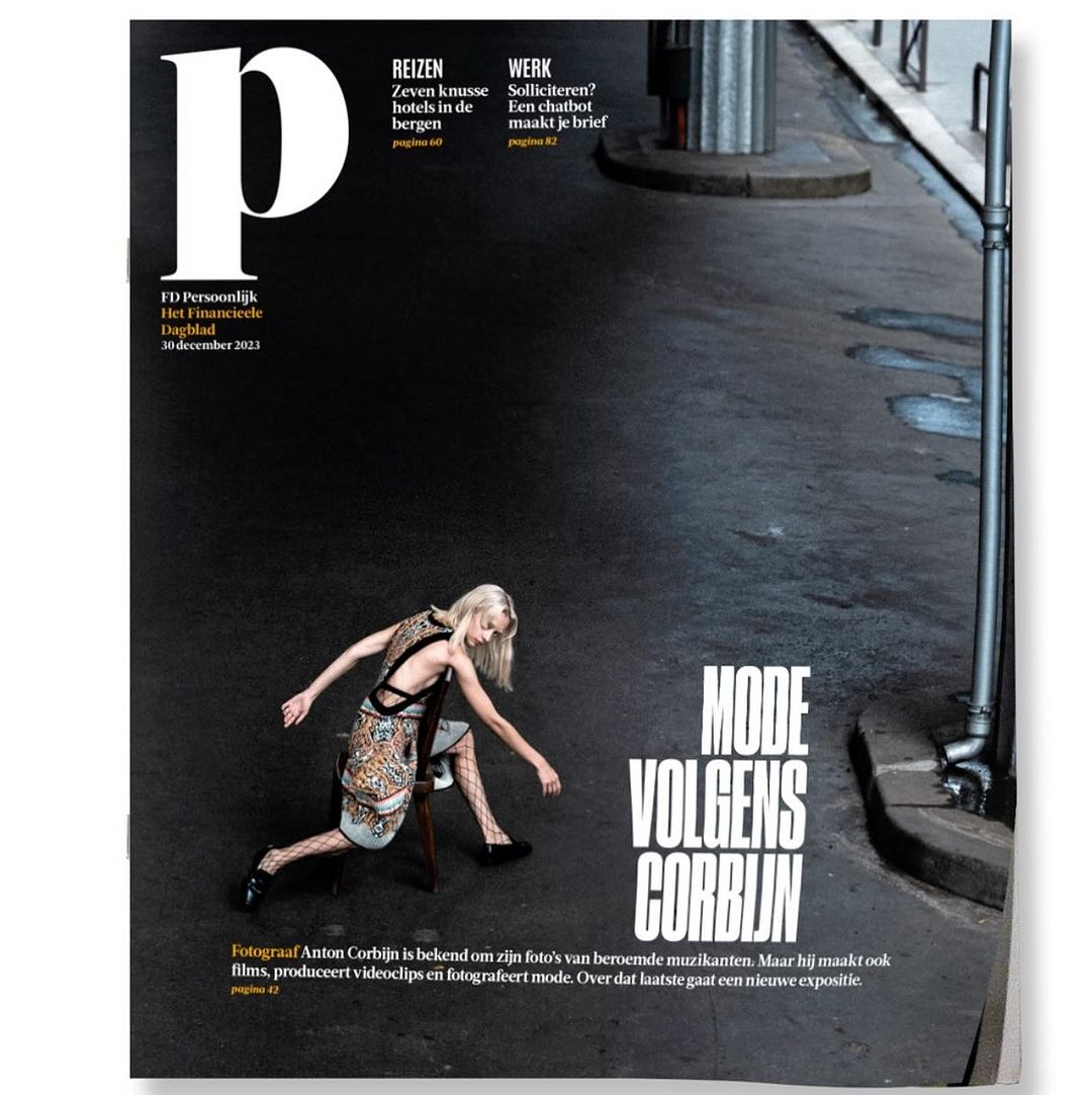 Magazine cover featuring a blonde woman posing on a chair on an asphalt street photographed by Anton Corbijn