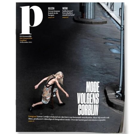 Magazine cover featuring a blonde woman posing on a chair on an asphalt street photographed by Anton Corbijn