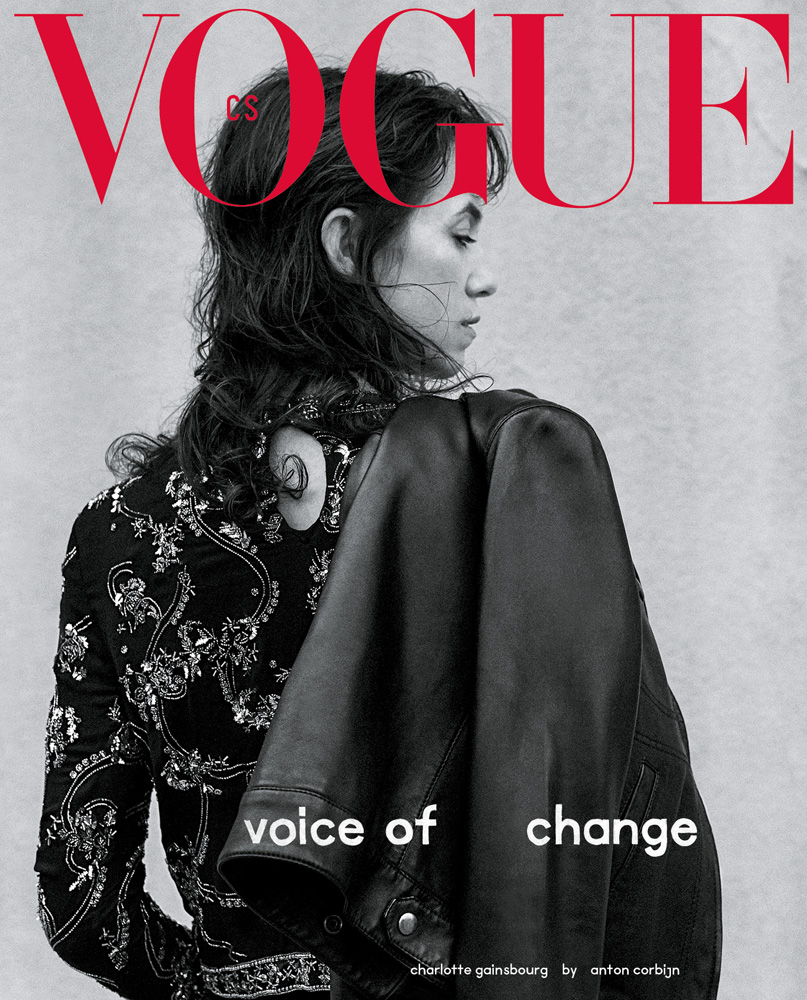 Vogue magazine cover featuring Charlotte Gainsbourg in embellished jacket, glancing to the side, with black leather jacket draped over shoulder.