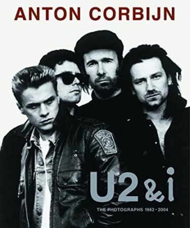 Black and white image of the rock band U2 on the cover of a book by Anton Corbijn, featuring four men in leather jackets.