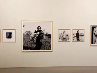 Exhibition gallery wall displaying framed black and white photography by Anton Corbijn.