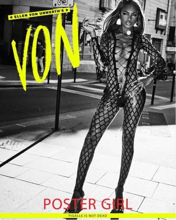 Model in black lattice cutout bodysuit standing on a city street holding a glass, by Ellen Von Unwerth.