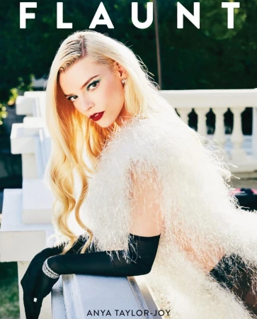 Anya Taylor-Joy poses for a magazine cover, wearing a white fuzzy top and long black gloves, with the magazine title 'Flaunt' above.
