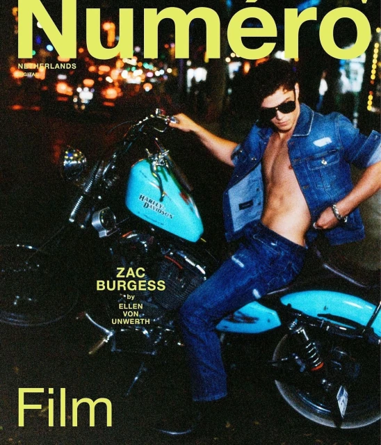 A man poses on a motorcycle on a city street at night in a fashion magazine cover featuring the magazine's title and model's name.
