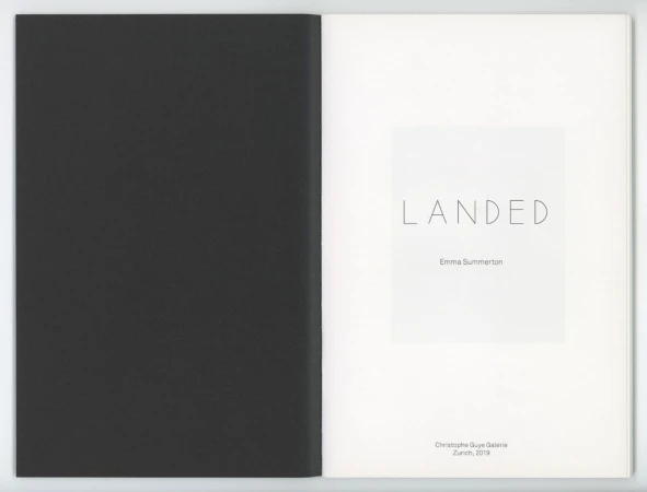 Open book displaying the title page with the word LANDED and artist name Emma Summerton