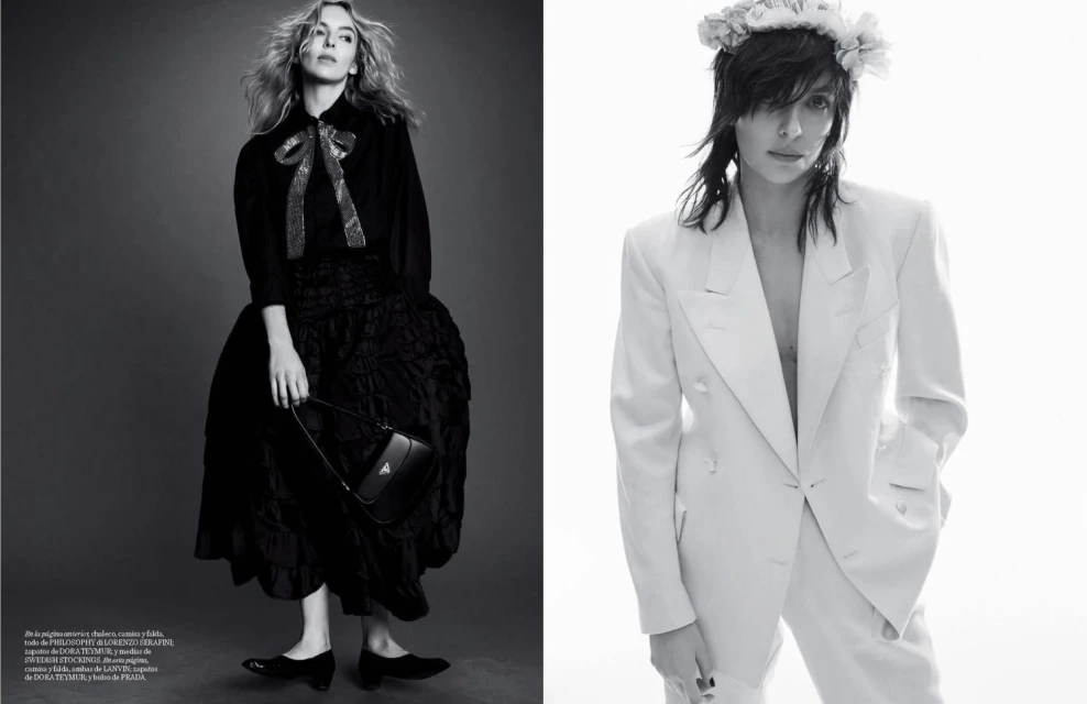 Monochrome fashion shot of two women, one in a black gown holding a Prada handbag, the other in a white suit with a floral headpiece.