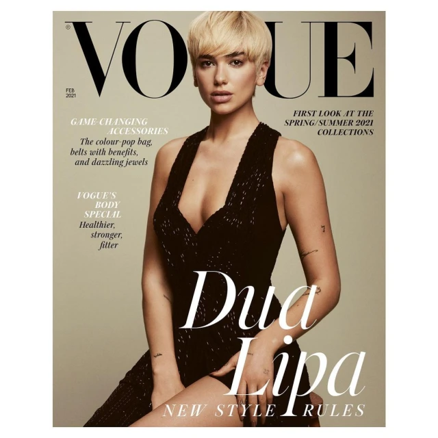 Vogue cover featuring Dua Lipa with short blonde hair wearing a dark dress, posing against a beige background, with magazine text.