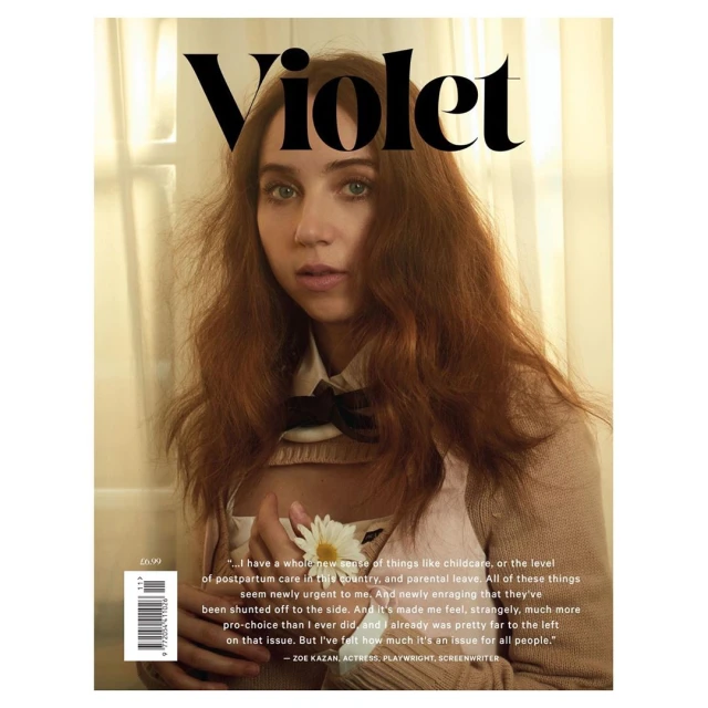 Magazine cover featuring a portrait of a young adult woman with long red hair, holding a white flower, and wearing a neutral-toned top.