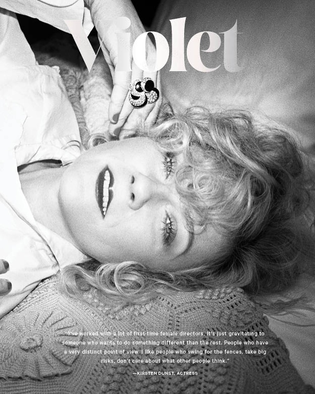 Black and white portrait of Kirsten Dunst lying down, with text overlay and focus on her face and an ornate ring.