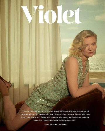 Kirsten Dunst poses in a beaded dress in front of a window with an ocean view in a celebrity and entertainment editorial shot.