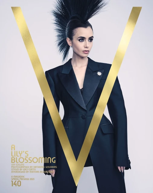 Lily Collins on the cover of V Magazine Spring Preview 2023 issue, wearing a tailored black suit, a V graphic, and dramatic Mohawk hairstyle.
