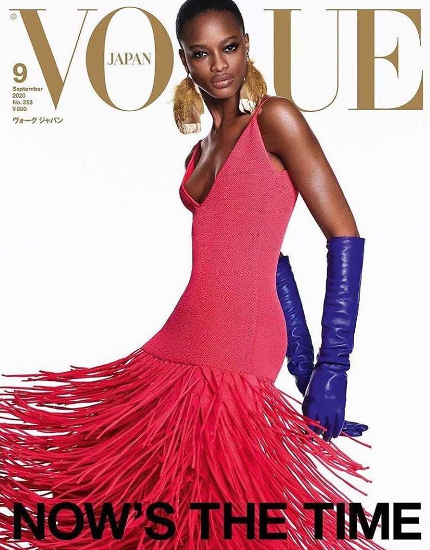 Vogue Japan magazine cover featuring a stylish Black model in a red dress with fringed details and blue gloves against a white backdrop.