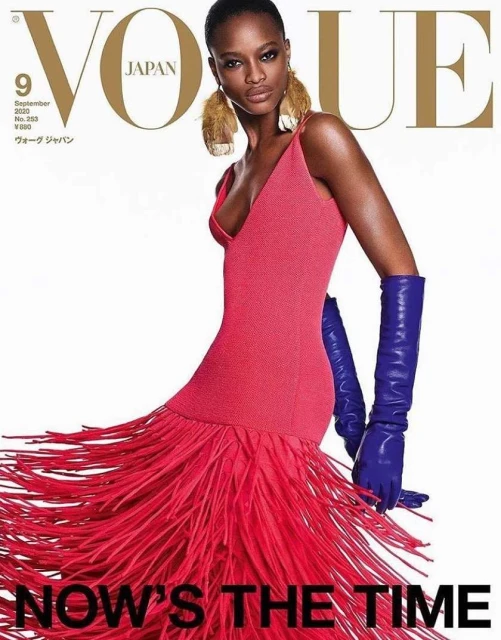 Vogue Japan magazine cover featuring a stylish Black model in a red dress with fringed details and blue gloves against a white backdrop.