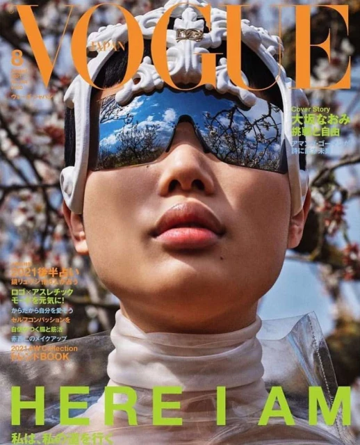 Vogue Japan cover featuring a person wearing reflective sunglasses and an ornate headpiece, set against a floral background.