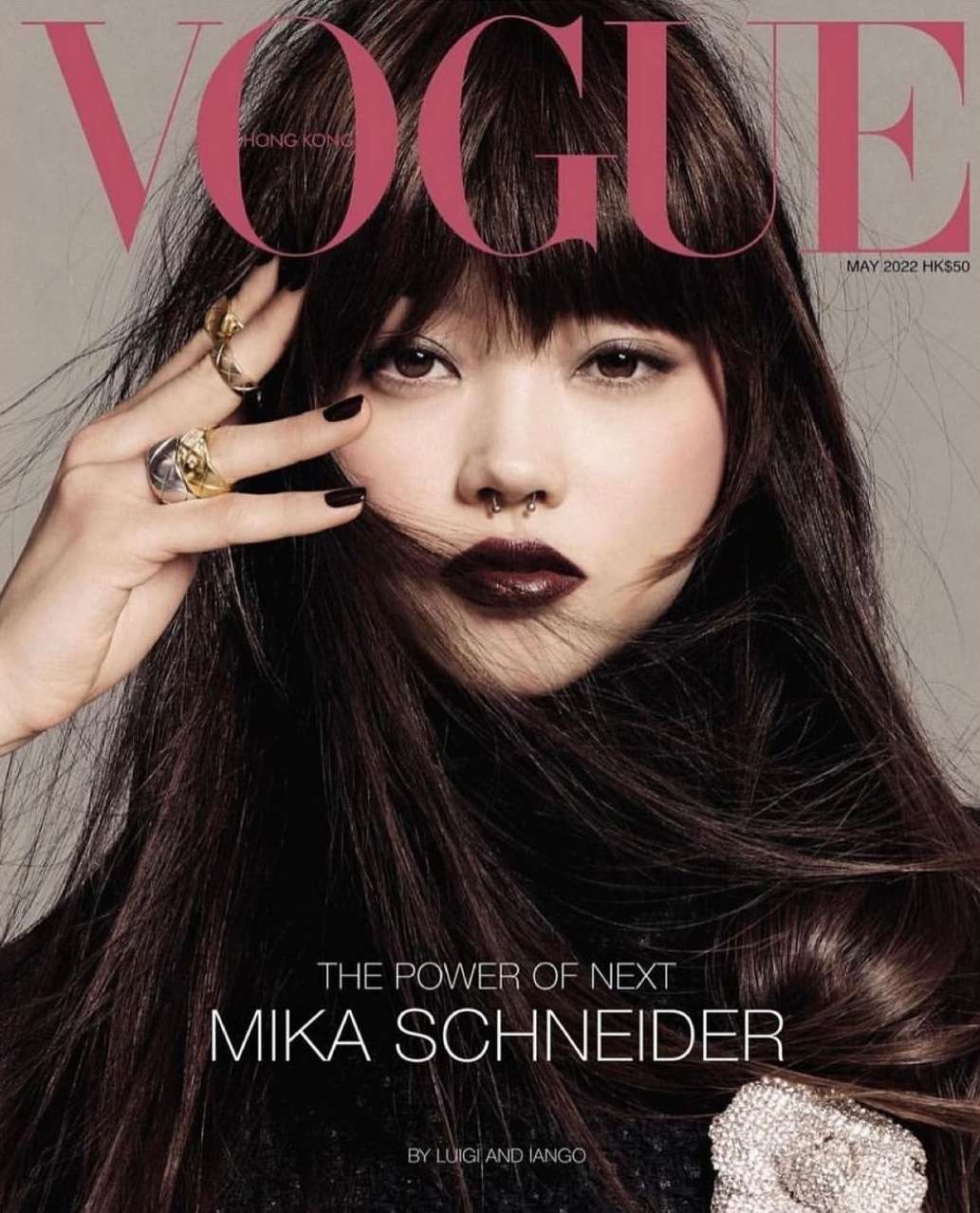 Vogue Hong Kong cover featuring model Mika Schneider with dark hair, wearing dark lipstick, and silver rings, May 2022 issue.