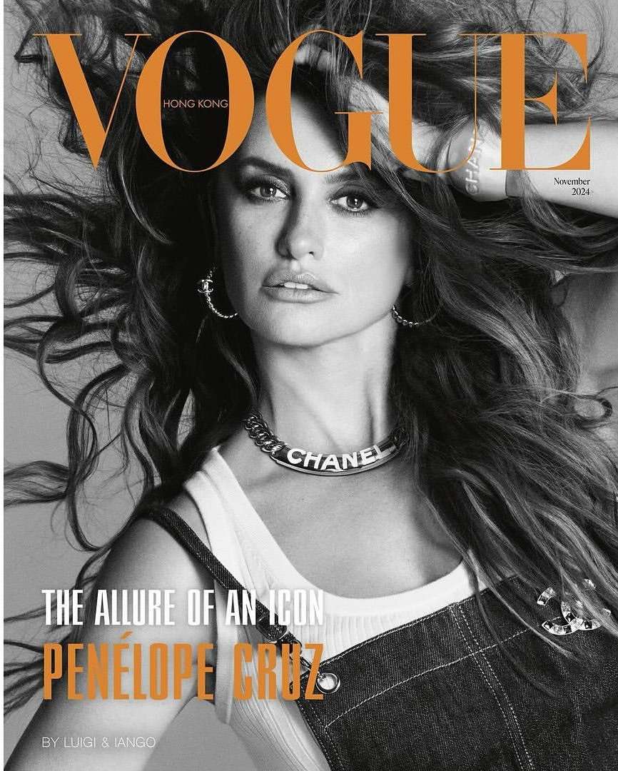 Vogue Hong Kong cover featuring Penelope Cruz in denim overalls, silver hoop earrings, and a Chanel choker necklace, with windswept brown hair.