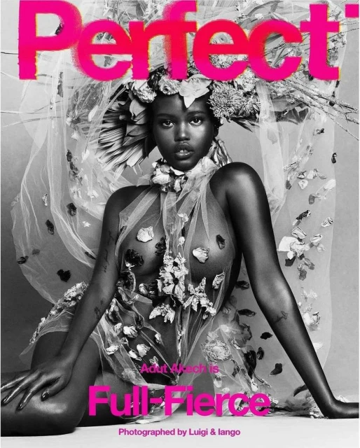 Portrait of a Black fashion model, Adut Akech, on a magazine cover, adorned with flowers, styled in sheer fabric, photographed in black and white.