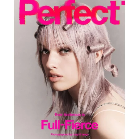 Magazine cover featuring a fair-skinned model with lavender-toned hair styled in sculpted curls posing against a neutral background.