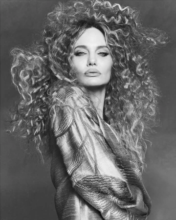 Monochrome portrait of Angelina Jolie featuring voluminous curly hair and a patterned top captured by Luigi and Iango
