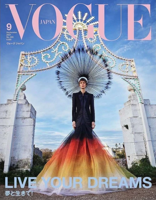 Vogue Japan September 2021 cover featuring a model in a black and colorful gown standing in front of an ornate stone archway.