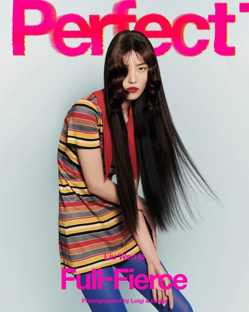 Magazine cover featuring an Asian female model with long dark hair, wearing a striped shirt and blue tights, posing against a light blue background.