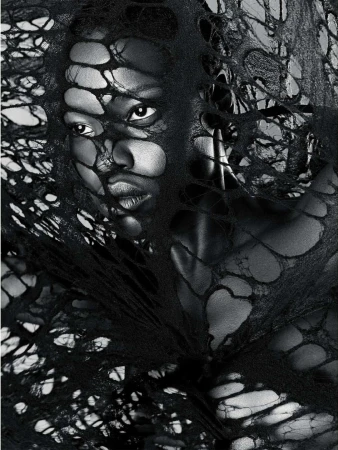 Monochrome portrait of an adult woman with short hair, wearing a dark garment with holes, against a light background in a studio.