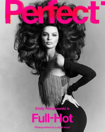 Emily Ratajkowski on a magazine cover with large voluminous dark hair, black dress and silver fringe on light gray background.