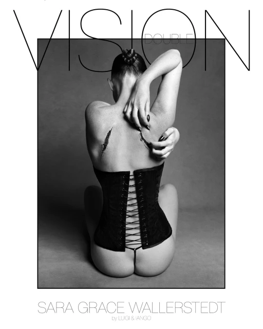 Back view of Sara Grace Wallerstedt, seated, wearing a corset with tied lacing, against a grey background. Text overlay. Fashion photography.