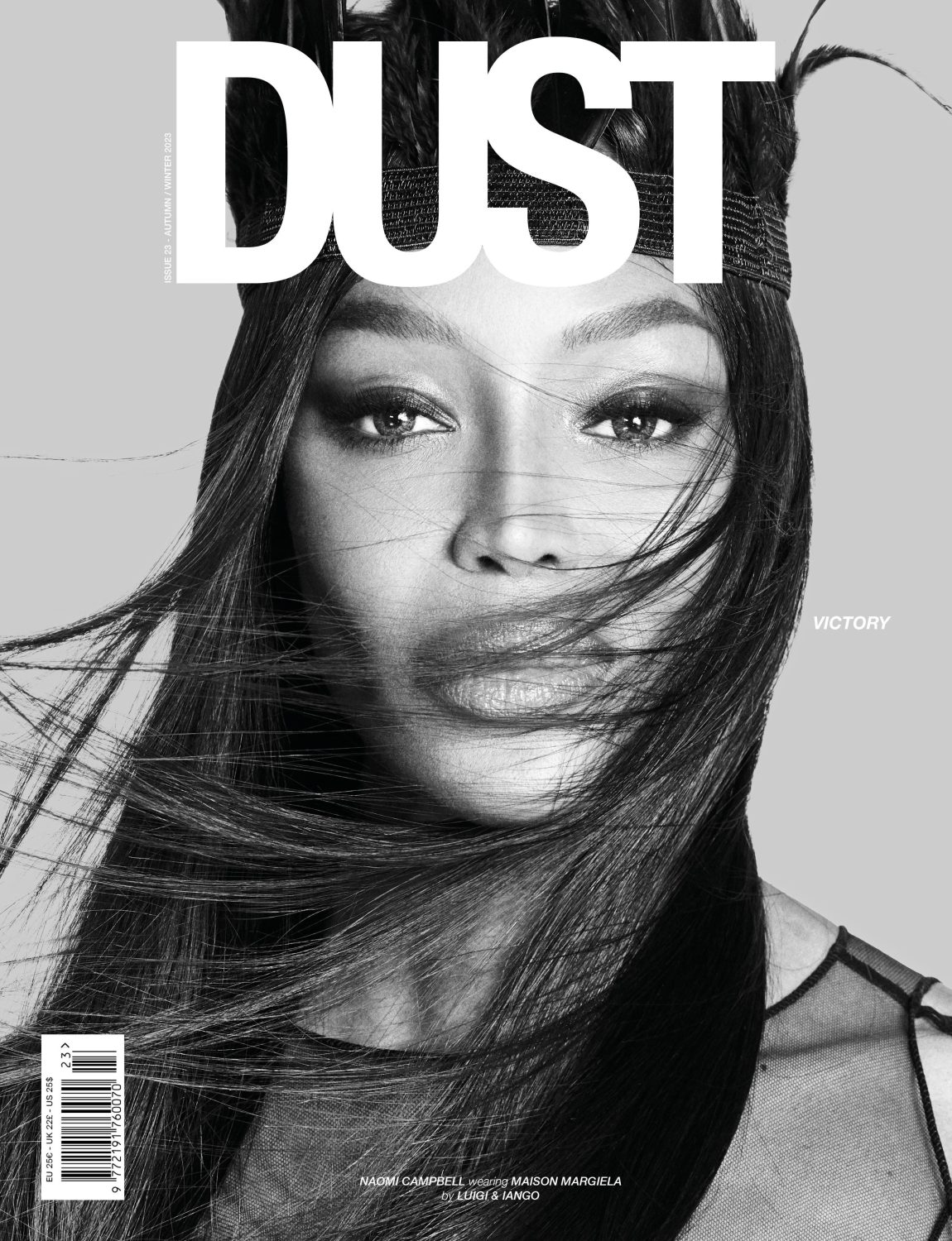 Black-and-white portrait of a woman with dark hair wearing a feathered headpiece for a magazine cover, with a shallow depth of field.