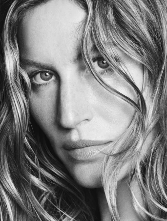Close-up black and white portrait of a woman with tousled hair falling across her face by photographers Luigi and Iango.