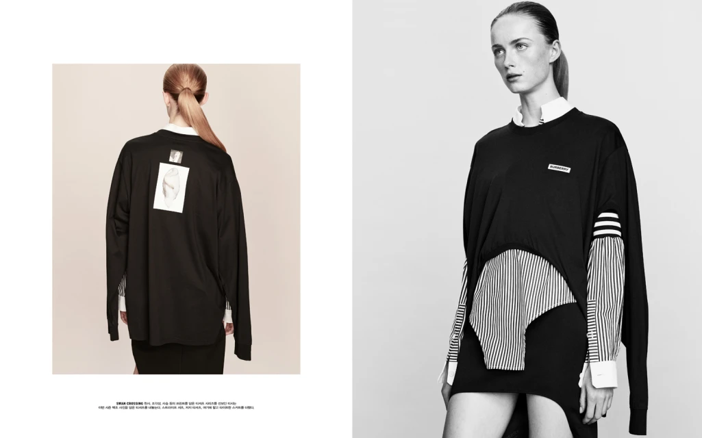 Black and white fashion photography of a slender woman in black tunic with white shirt and striped sleeves, cool tone, back view on left.
