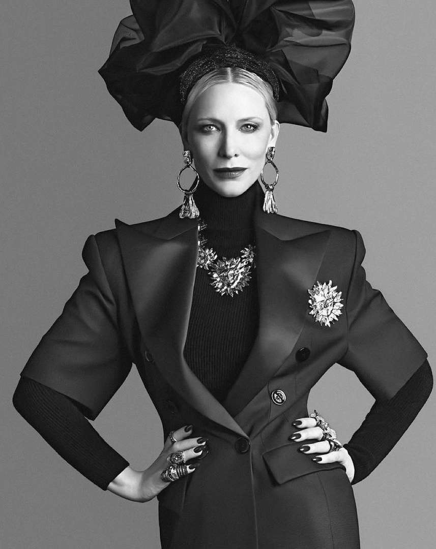Cate Blanchett in a structured black blazer and large sculptural headpiece photographed by Luigi & Iango in monochrome.