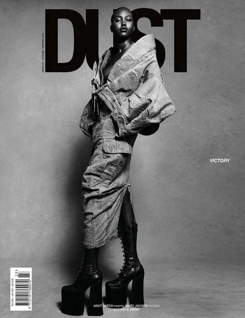 Black and white fashion magazine cover featuring a Black woman in a patterned jacket, skirt, platform boots, and bold 'DUST' typography.