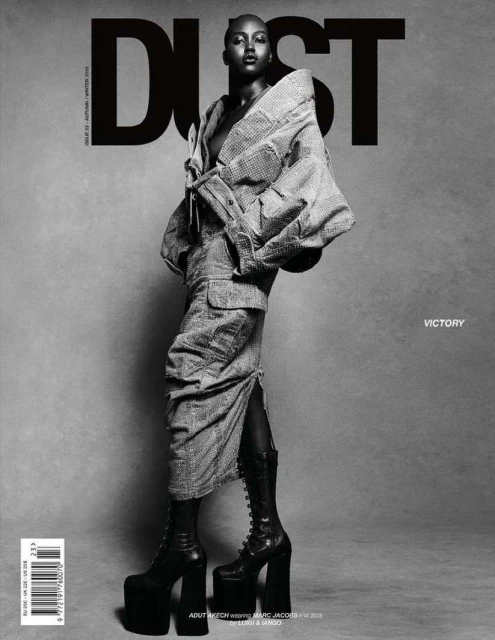 Black and white fashion magazine cover featuring a Black woman in a patterned jacket, skirt, platform boots, and bold 'DUST' typography.