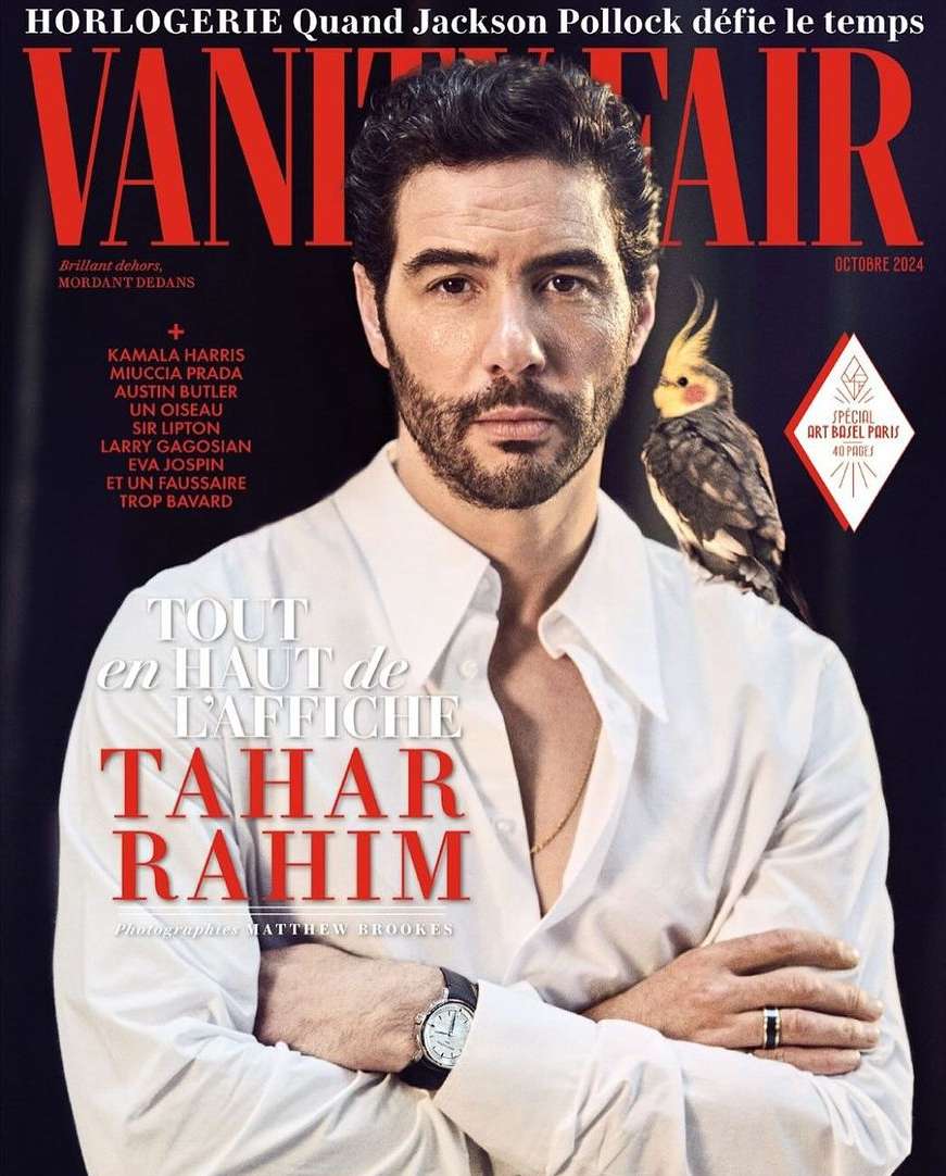 Vanity Fair cover featuring Tahar Rahim with a cockatiel perched on his shoulder, set against a dark background with magazine text.