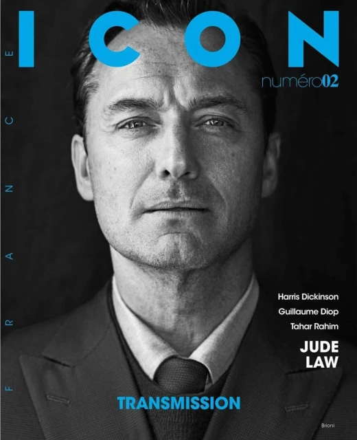 Black and white portrait of actor Jude Law on a magazine cover, featuring blue text reading ICON numero02 and TRANSMISSION.