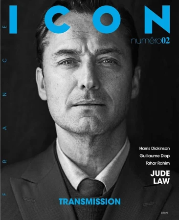 Black and white portrait of actor Jude Law on a magazine cover, featuring blue text reading ICON numero02 and TRANSMISSION.