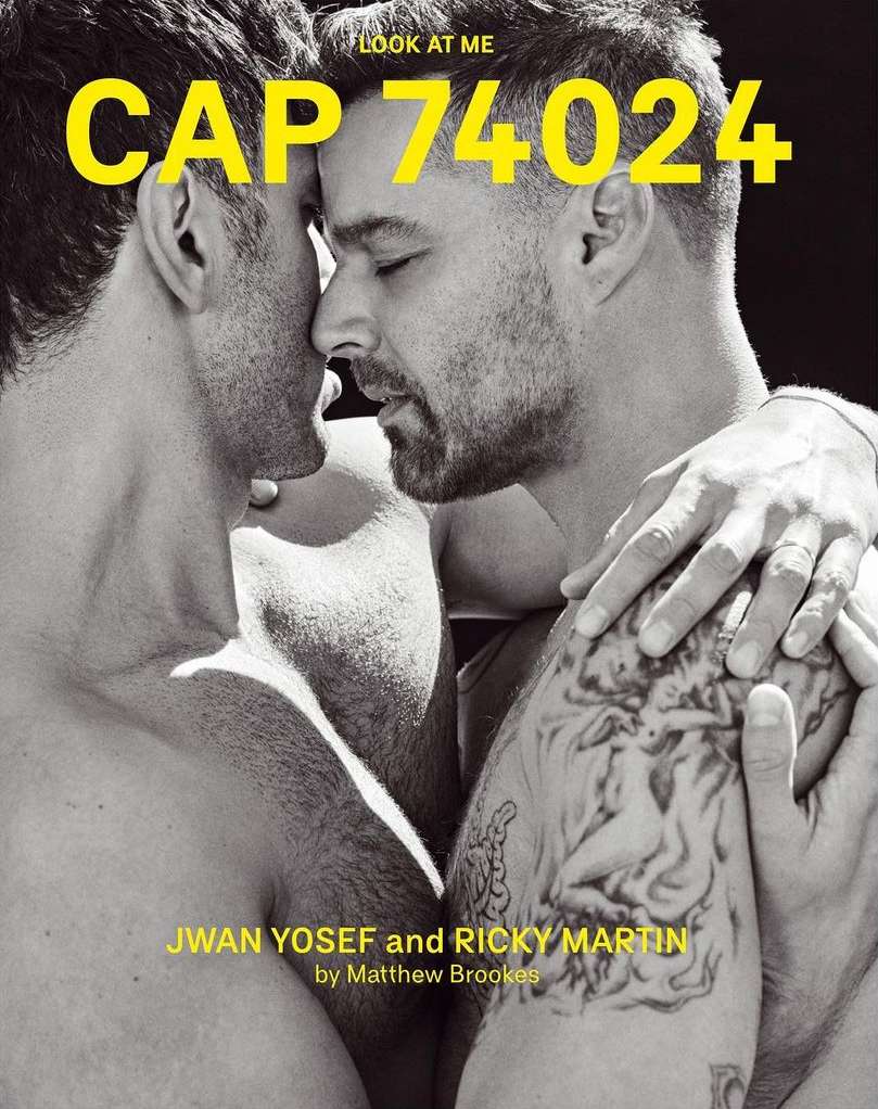 Black and white portrait of two adult men, with close facial proximity, one with a visible arm tattoo and overlaid yellow magazine text.