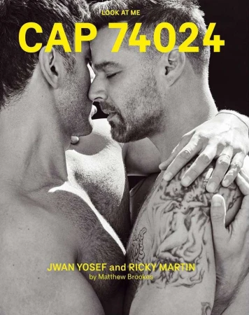 Black and white portrait of two adult men, with close facial proximity, one with a visible arm tattoo and overlaid yellow magazine text.