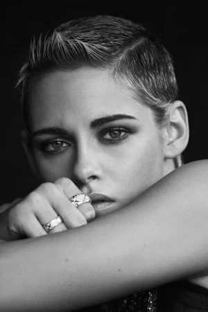 Close-up portrait of Kristen Stewart with short cropped hair and rings on her fingers, directed by Matthew Brookes.