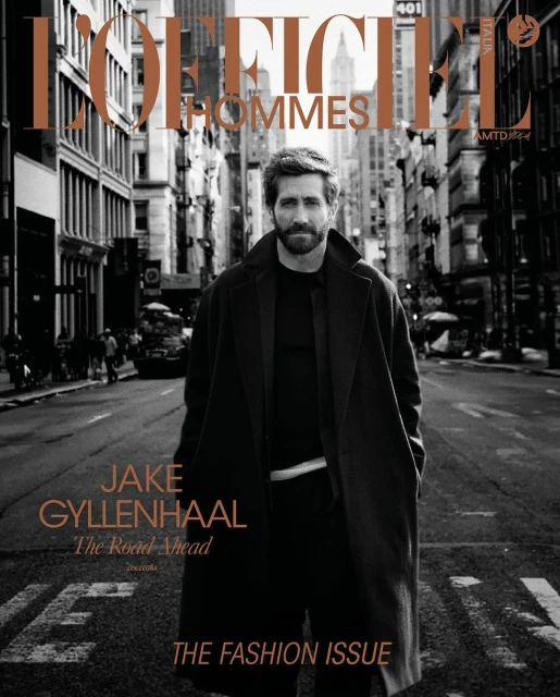 Magazine cover featuring Jake Gyllenhaal on a city street in a dark coat. L'Officiel Hommes header. Fashion issue focus.
