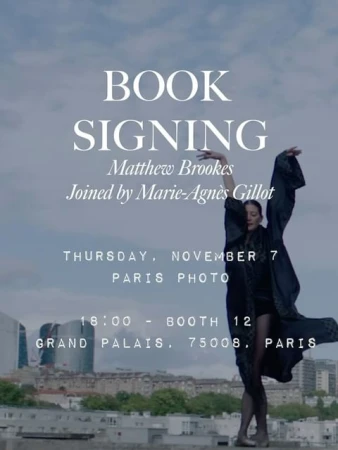 Elegant event poster featuring a woman in flowing robe striking a pose against a Paris cityscape, advertising a book signing.